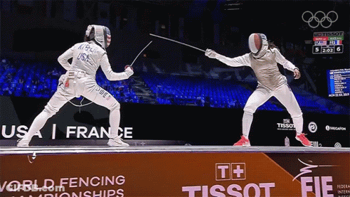 Two Fencers Are Fighting In Front Of A Tissot Sign GIF
