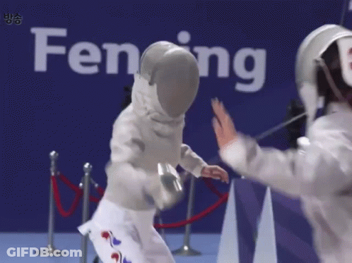 Two Fencers Are Giving Each Other High Fives In Front Of A Sign That Says Fencing GIF