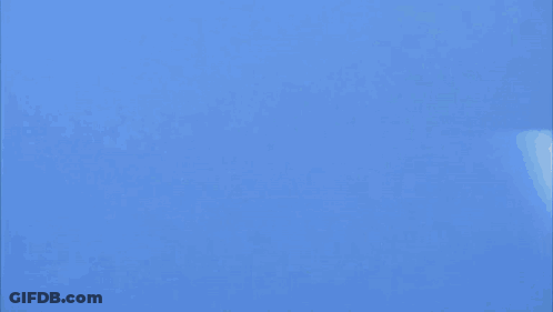 Two Fighter Jets Are Flying In A Blue Sky And One Of Them Has The Letter K On It GIF