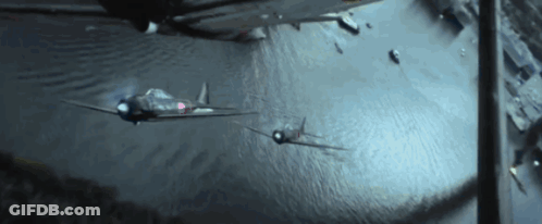 Two Fighter Jets Are Flying Over A Body Of Water At Night GIF