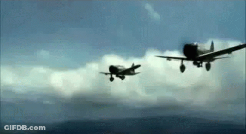 Two Fighter Planes Are Flying In The Sky . GIF