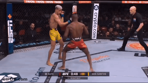 Two Fighters Are Fighting In A Boxing Ring With A Sign That Says Crypto.com GIF