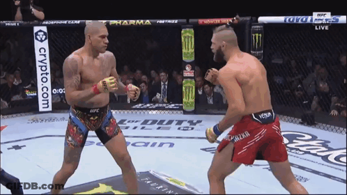 Two Fighters Are Fighting In A Ring With A Crypto.com Banner On The Side GIF