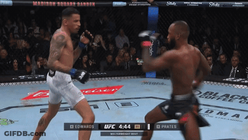 Two Fighters Are Fighting In A Ufc Ring And One Of Them Is Wearing White Shorts GIF