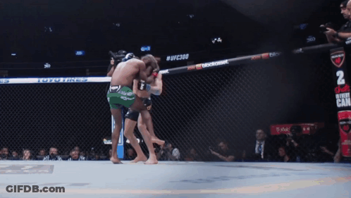 Two Fighters Fighting In Cage With UFC2010 GIF