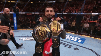 Two Fighters Holding Up Their Ufc Belts In Front Of A Bud Light Banner GIF