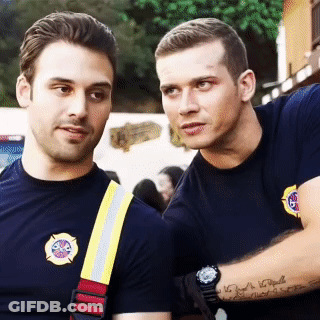 Two Firefighters Are Standing Next To Each Other And One Has A Tattoo On His Arm That Says ' I Love You ' GIF