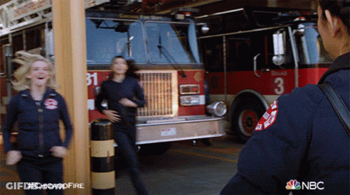 Two Firefighters In Front Of Fire Truck With Number 3 GIF