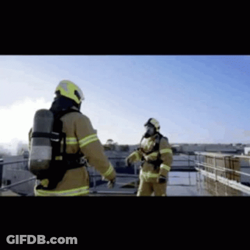 Two Firefighters Standing On Roof GIF