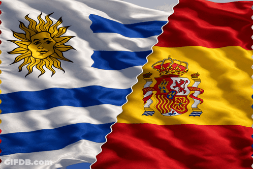 Two Flags One From Uruguay And The Other From Spain Are Waving In The Wind GIF