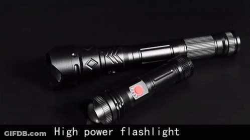 Two Flashlights Are Sitting On A Black Surface . GIF