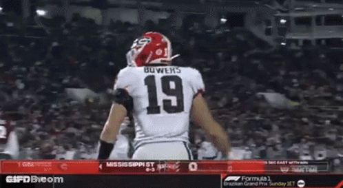 Two Football Players Are Celebrating A Touchdown During A Game On Espn GIF
