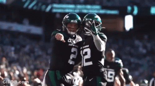 Two Football Players Are Hugging Each Other And One Has The Number 2 On His Jersey GIF