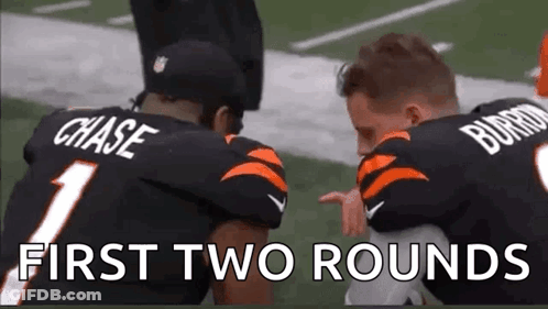 Two Football Players Are Kneeling On The Field . GIF