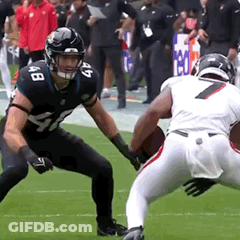 Two Football Players Are Playing A Game On A Field And One Has The Number 7 On His Jersey GIF