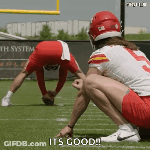 Two Football Players Are Squatting On The Field And One Of Them Says It 'S Good GIF