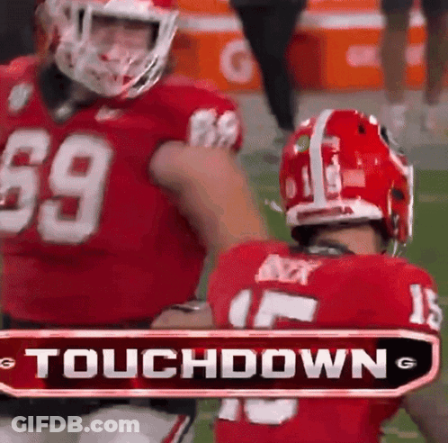 Two Football Players Are Standing Next To Each Other With A Touchdown Sign In The Background GIF