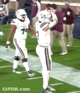 Two Football Players Are Standing On The Field And One Has The Number 7 On His Shirt GIF