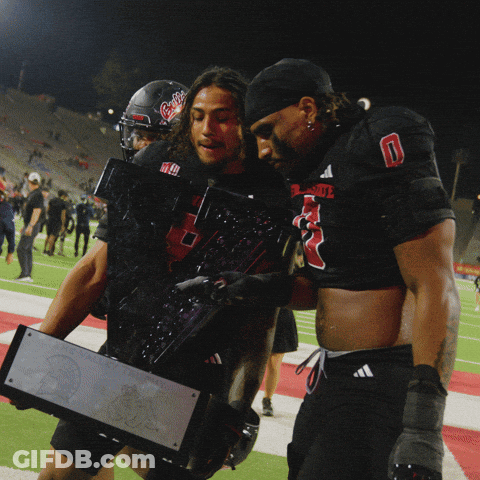 Two Football Players Carrying Trophy Number 5 GIF