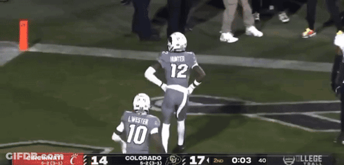 Two Football Players Celebrating Touchdown With Referee GIF