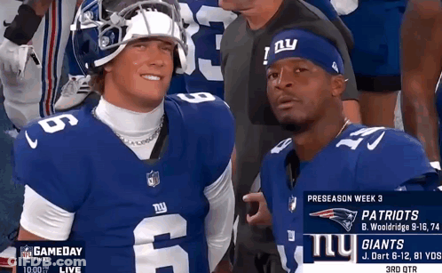 Two Football Players For The New York Giants Are Posing For A Photo GIF