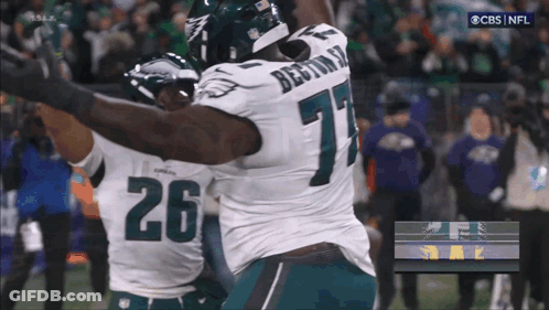 Two Football Players Hugging Number 26 GIF