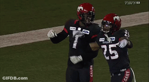 Two Football Players Hugging On Field GIF