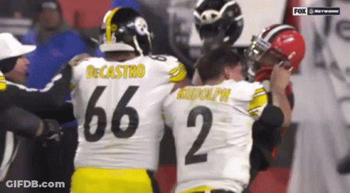 Two Football Players Hugging, One With Number 35 Jersey GIF