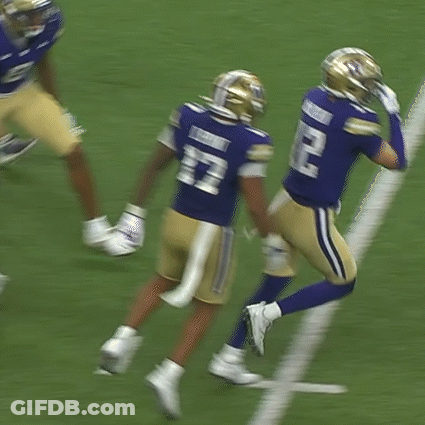 Two Football Players In Blue Uniforms With Letter W GIF