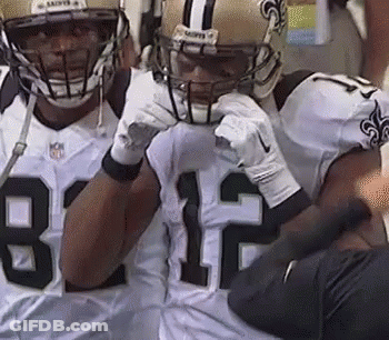 Two Football Players In Helmets On Sidelines GIF