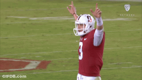 Two Football Players In State Jerseys Dancing By Tree GIF