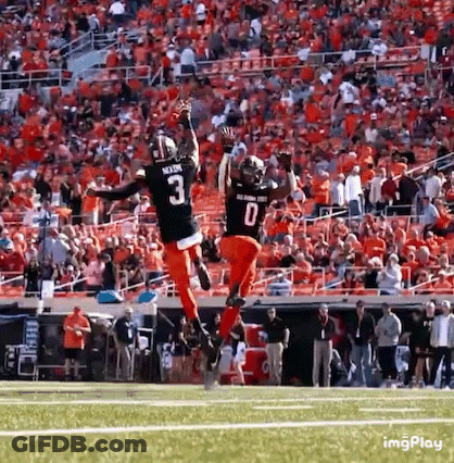Two Football Players Jumping In Air GIF