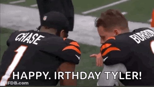 Two Football Players Kneeling Holding Child GIF