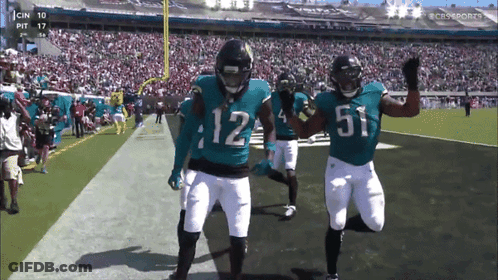 Two Football Players Number 12 And 51 GIF