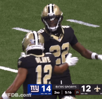 Two Football Players On A Field With A Scoreboard That Says Ny 14 GIF