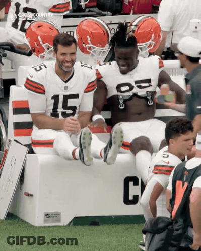 Two Football Players On Bench Number 15 GIF