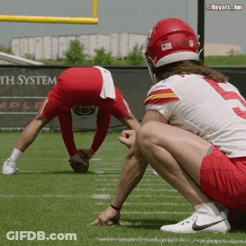 Two Football Players On Field With System Sign GIF