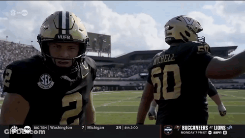 Two Football Players One Of Whom Has The Number 50 On The Back Of His Jersey GIF