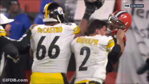 Two Football Players One Of Whom Has The Number 66 On Their Jersey GIF