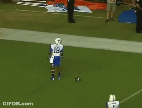 Two Football Players One Of Whom Is Wearing Number 1 GIF