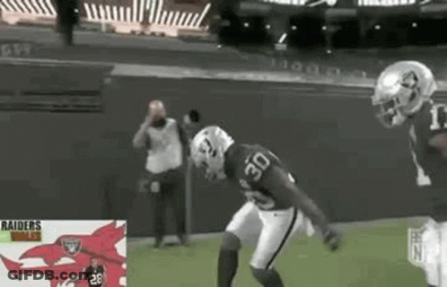 Two Football Players Playing Game One Wearing Number 30 Jersey GIF