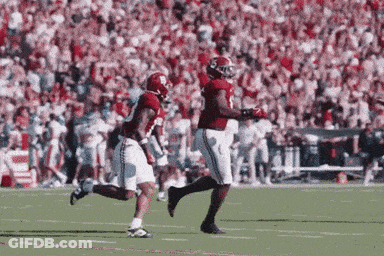 Two Football Players Running On Field GIF