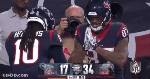 Two Football Players Standing On Field GIF