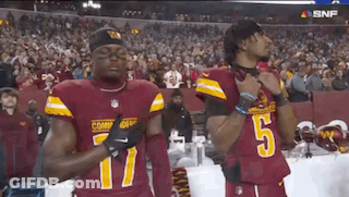 Two Football Players Standing On Field GIF