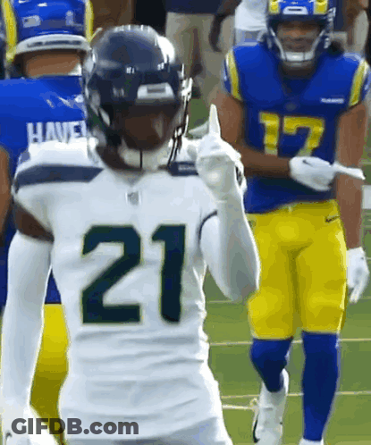 Two Football Players Standing On Field GIF