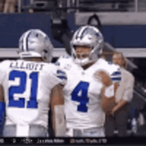 Two Football Players Standing On Field GIF