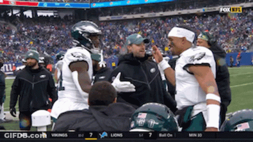 Two Football Players Talking On Field GIF