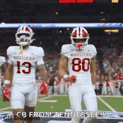 Two Football Players Walking On Field Number 80 Jersey GIF