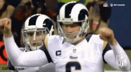 Two Football Players Wearing Helmets And Jerseys With The Letter C On Them GIF