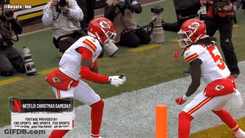 Two Football Players With Netflix Christmas Gameday Sign GIF
